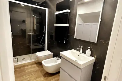 a bathroom with a sink and a toilet and a mirror at Roma city center stay San Giovanni in Rome