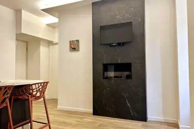 a living room with a tv on a wall at Roma city center stay San Giovanni in Rome