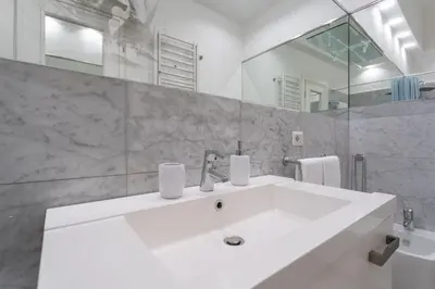 a bathroom with a white sink and a mirror at Pgrhome Civinini in Rome