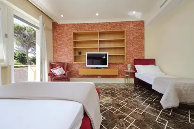 a bedroom with two beds and a flat screen tv at YCH-Elegante appartamento vicino Villa Ada in Rome