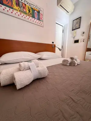a bedroom with two towels on a bed at 600mt To Colosseum in Rome