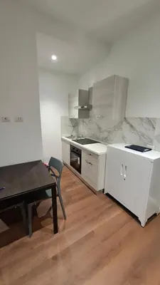 a kitchen with white counters and a table and a table and a table sidx sidx at Pigneto New collection 1 in Rome