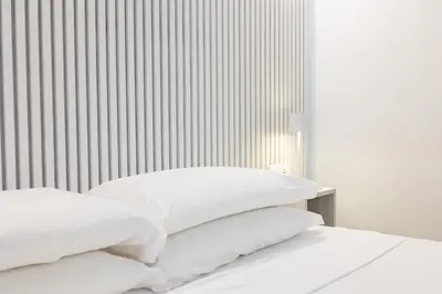 two white pillows on a bed in a bedroom at Rome Capital Apartments in Rome