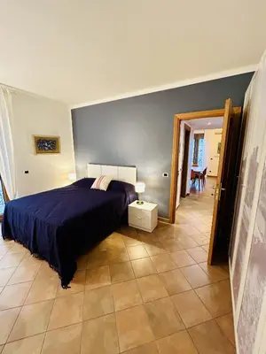 a bedroom with a bed with a blue comforter at casa di Stefano in Vaticano in Rome