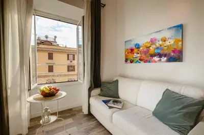 a living room with a white couch and a window at Apartment near the Vatican in Rome