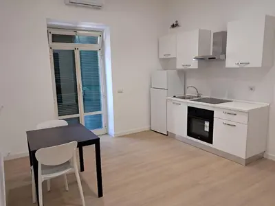 a kitchen with a black table and a table and chairs at Pigneto New collection 2 Casilina in Rome