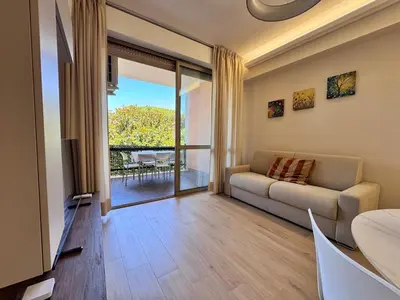 a living room with a couch and a view of a patio at Luxury Apartment Metro Cornelia in Rome