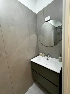 a bathroom with a sink and a mirror at The Roman Retreat - 2BDR Colosseum Monti district in Rome