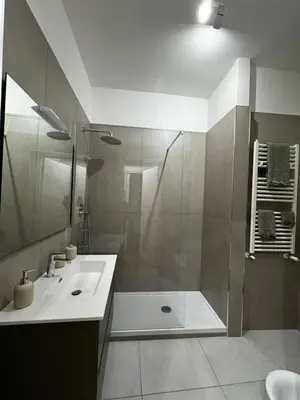 a bathroom with a shower and a sink at The Roman Retreat - 2BDR Colosseum Monti district in Rome