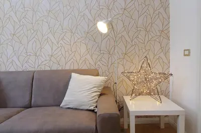 a living room with a couch and a star on a wall at Circo Massimo House by Luxury Getaways in Rome