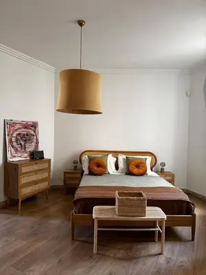 a bedroom with a bed with pillows and a table at Roman Holiday Escape 2BDR Spanish steps and Trevi in Rome
