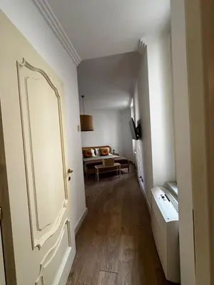 a hallway with a door leading to a living room at Roman Holiday Escape 2BDR Spanish steps and Trevi in Rome