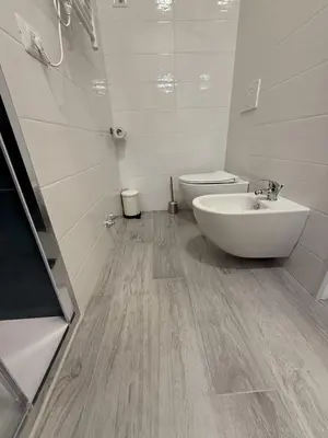 a white bathroom with a sink and a toilet at Nest Love collazia Roma 1500 mt dal Colosseo in Rome