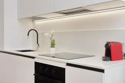 a kitchen with a sink and a red appliance at Contemporary Apartment by Luxury Getaways in Rome