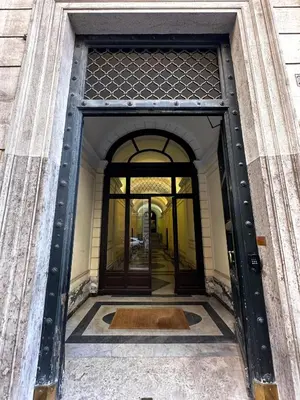 an entrance to a building with a revolving door at Fontart Tritone in Rome