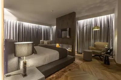 a bedroom with a large bed and a chair at Fontart Tritone in Rome