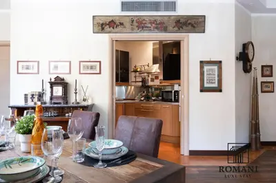 a dining room with a table and a kitchen at Luxury Vatican Suite with Sauna in Rome