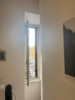 a window in a room with a view of a city at Testaccio Immobiliare in Rome