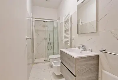 a bathroom with a shower and a sink and a toilet at Poliziano Boutique Apartment in Rome