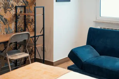a living room with a blue couch and a chair at Casa Mia San Pietro in Rome