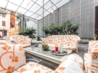 a patio with couches and a table on a patio at Raeli Hotel Lazio in Rome