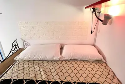 a bed with two white pillows on top of it at Un cuore nella città eterna in Rome