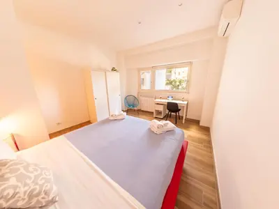a small bedroom with a bed and a desk at New Cozy APT, close to Downtown in Rome