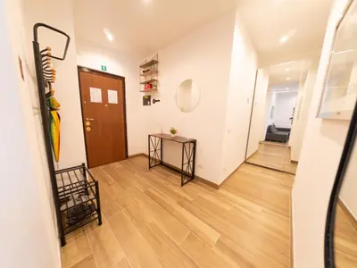 a hallway with a door and a table in a room at New Cozy APT, close to Downtown in Rome