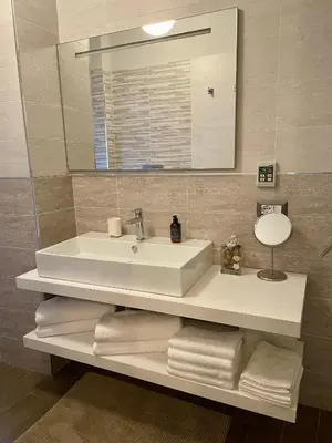 a bathroom with a sink and a mirror and towels at I Love San Pietro in Rome