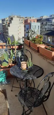 a table and chairs on a balcony with plants at Casa Fradella in Rome