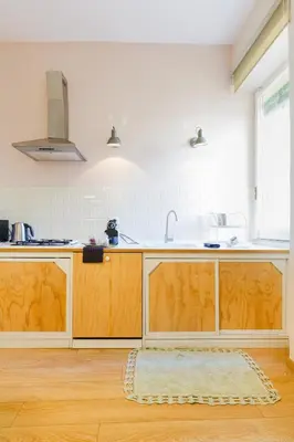 a kitchen with wooden cabinets and a sink at Lovely apt in Rome! in Rome