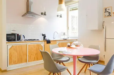 a kitchen with a pink table and chairs at Lovely apt in Rome! in Rome
