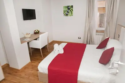 a bedroom with a bed with a red and white blanket at Spanish Steps House Vittoria in Rome