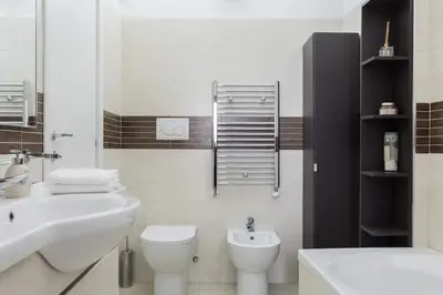 a white bathroom with a sink and a toilet at Spanish Steps House Vittoria in Rome