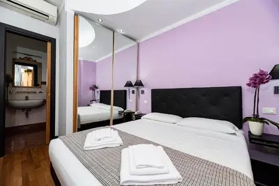 a bedroom with a large bed with towels on it at Imperium Suite Navona in Rome