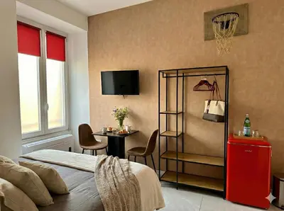 a bedroom with a bed and a table and a tv at Vatican City Deluxe - Suite con bagno privato - Vaticano a piedi in Rome