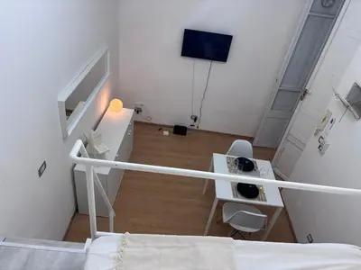 a bedroom with a bed and a tv in a room at Golden Suite - un piccolo loft nel cuore di Roma in Rome