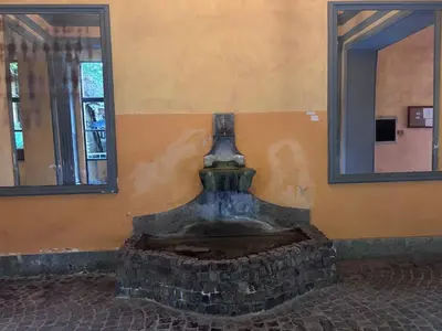 a vase sitting next to a wall with two mirrors at Golden Suite - un piccolo loft nel cuore di Roma in Rome