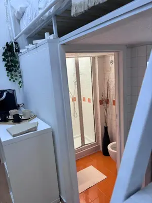 a kitchen with a white refrigerator and a toilet at Golden Suite - un piccolo loft nel cuore di Roma in Rome