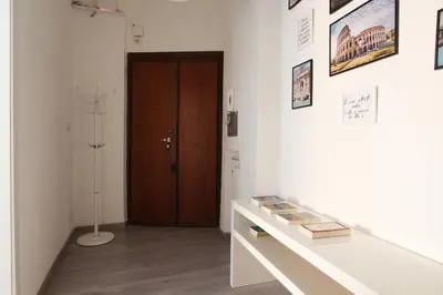 a room with a table with books and a door at Porta Portese Luxury Suites in Rome