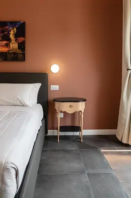 a bedroom with a bed and a small table at Flora Guest House in Rome