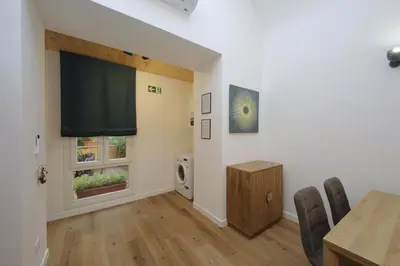 a dining room with a table and a television at Holy Mary Lovely Apartment in Rome