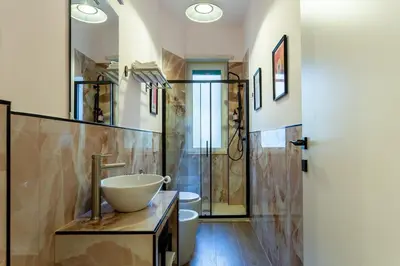 a bathroom with a bowl sink and a shower at Furio Flat in Rome