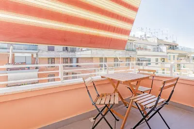 a table and chairs on a balcony with a view at Luciano Boutique Apartment in Rome