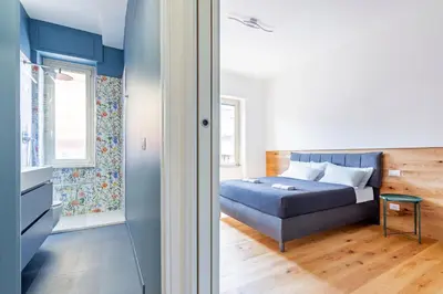a bedroom with a bed and a window at Luciano Boutique Apartment in Rome