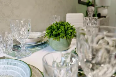 a table with glasses and a potted plant on it at Menghini Easy Flat in Rome
