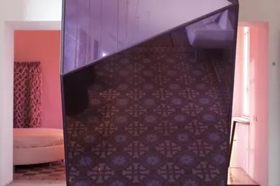 a room with a staircase with a purple wall at 3000rome Di Parione in Rome