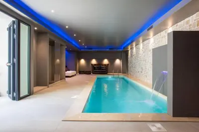 a swimming pool in a house with blue lighting at Fortyfive Squared Hotel in Rome
