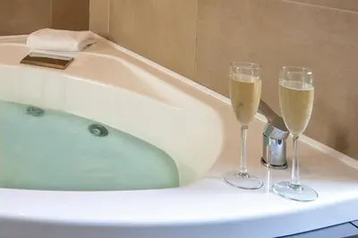 a bath tub with two glasses of champagne at Fortyfive Squared Hotel in Rome