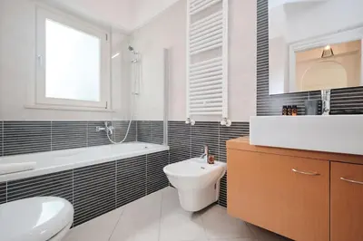 a bathroom with a sink and a toilet and a bath tub at Trastevere-Colosseo, Elegant Apartment Wi-Fi & A-C in Rome